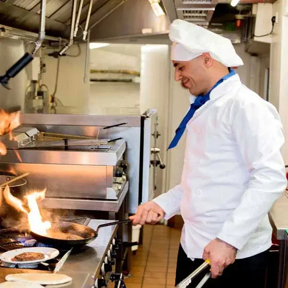 Azalea Estates Chef Created Meals, chef frying a dish.