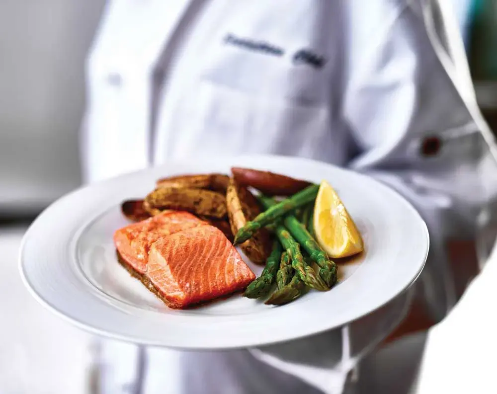 Azalea Estates Chef Created Meals, chef delivering a finished dish.